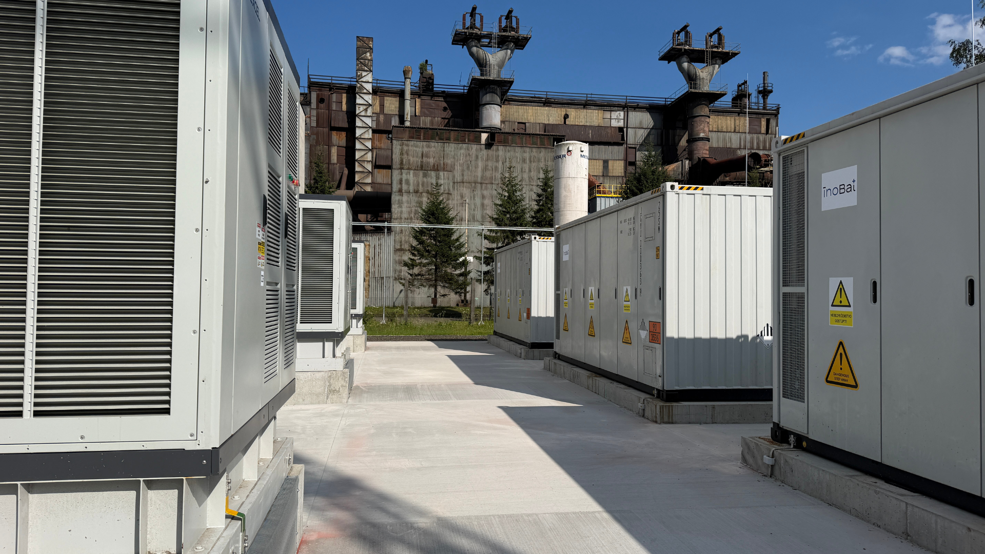 BESS containers and power conversion cabinets in front of the OFZ metallurgical plant